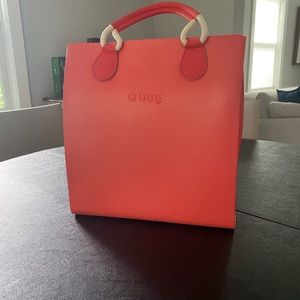 O Bag beach bag in coral with handle & backpack strap.